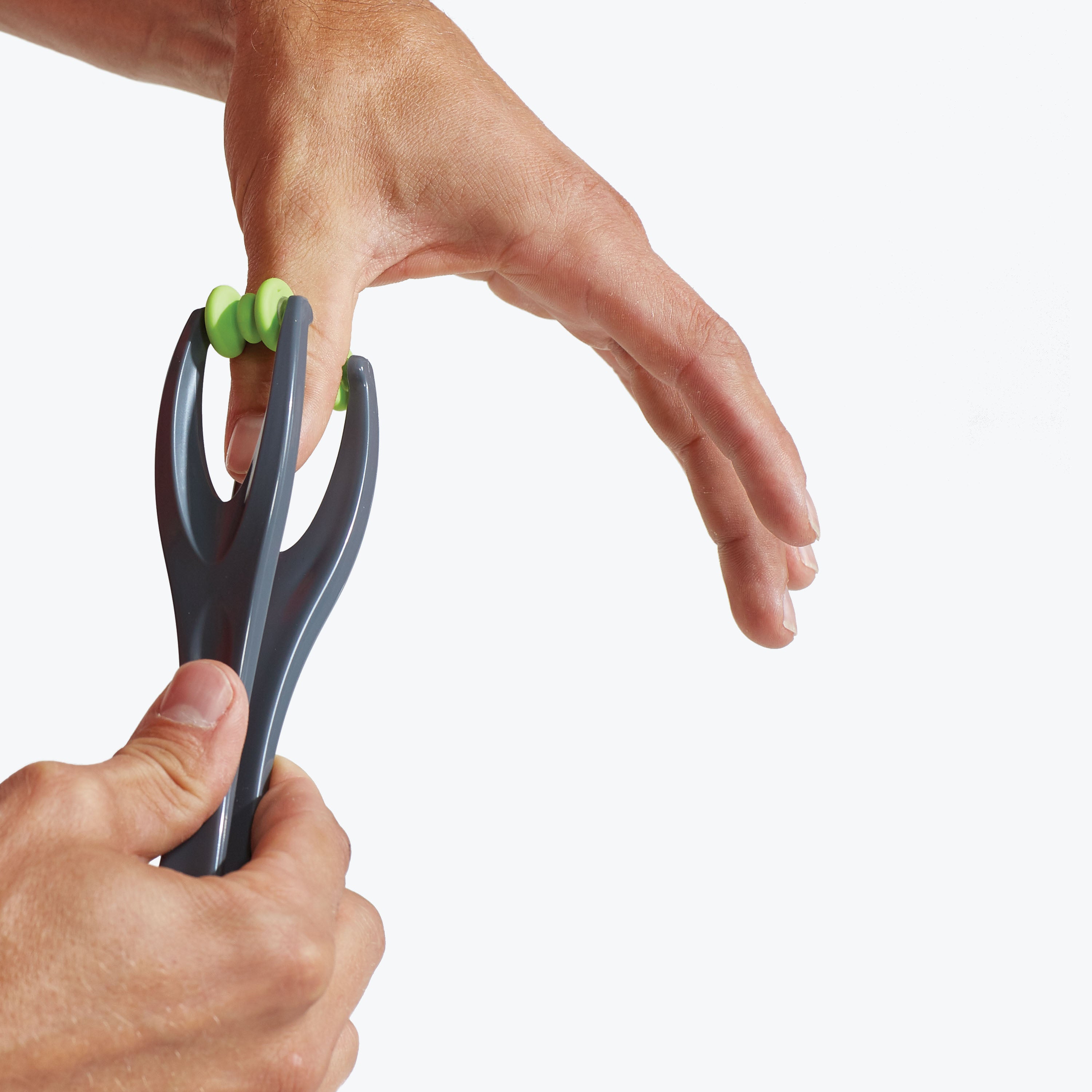 Person using the Dual Finger Massager in thumb up-close